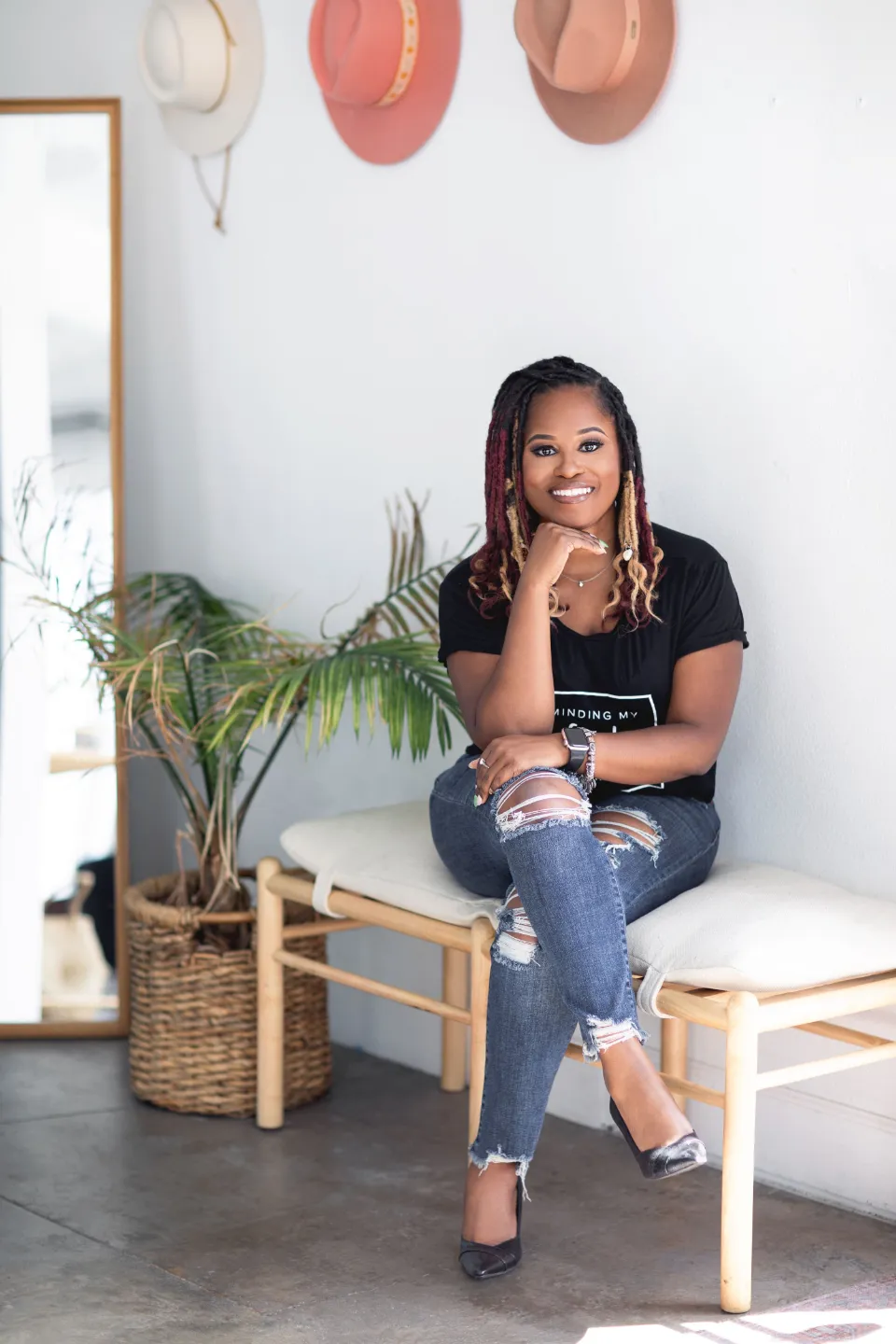 Yvette Howard, LCSW, Private Practice Strategist, Boss Clinician, seated on a bench and smiling